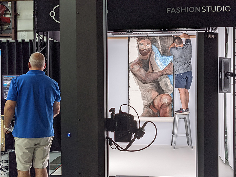 Large artwork being pinned in Fashion Studio
